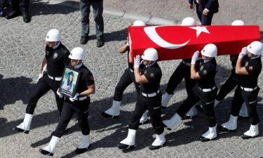 A guard of honour carries the Turkish flag-draped coffin of Aysenur Ezgi Eygi during her funeral ceremony in Didim.