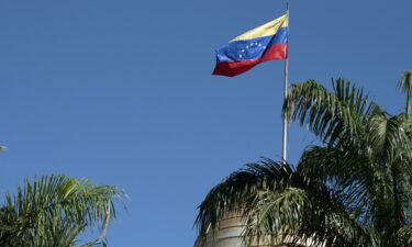 The Venezuelan flag flies over the National Assembly building in Caracas