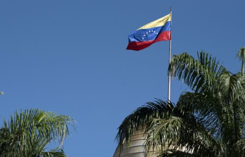 The Venezuelan flag flies over the National Assembly building in Caracas