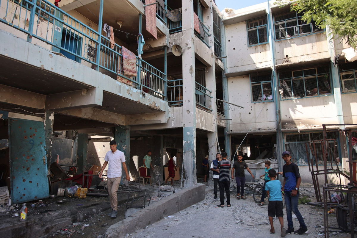 <i>Omar Al-Qattaa/AFP/Getty Images via CNN Newsource</i><br/>Palestinians inspect the damage at the site of the Israeli strike.