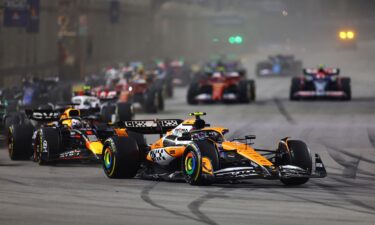 McLaren's Lando Norris leads into the first corner at the start of the race.