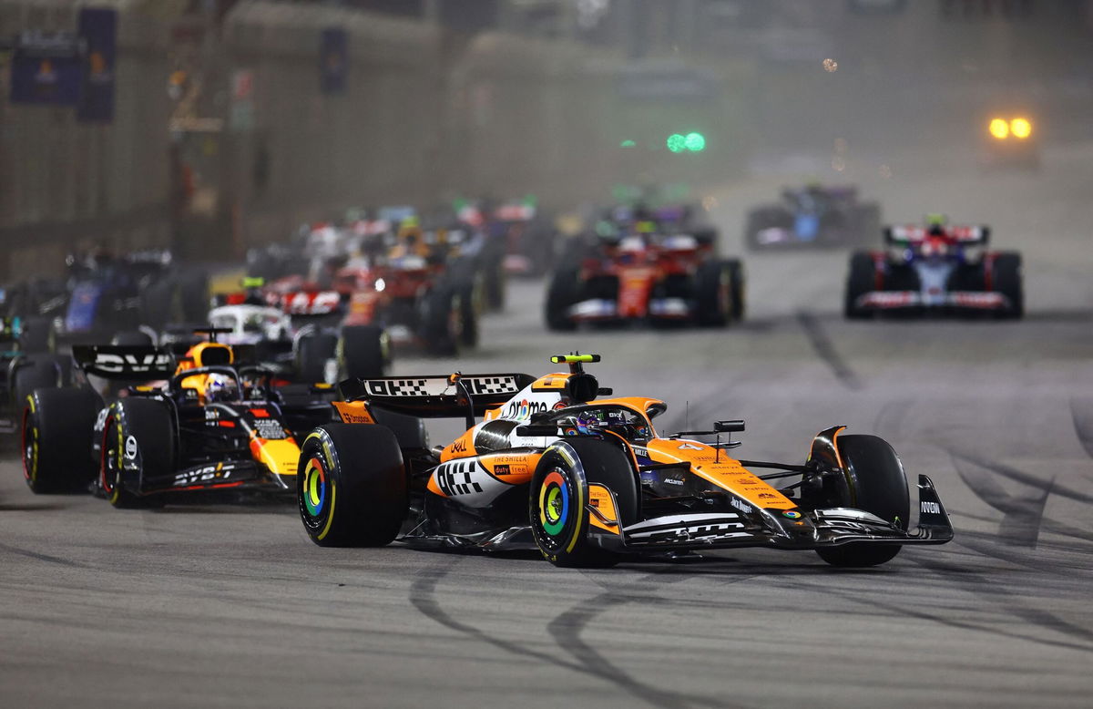 <i>Edgar Su/Reuters via CNN Newsource</i><br/>McLaren's Lando Norris leads into the first corner at the start of the race.