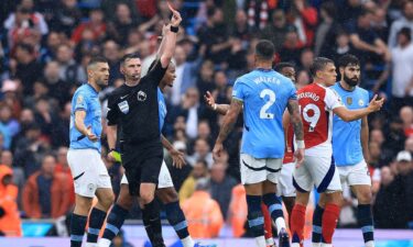 Trossard is dismissed by referee Michael Oliver.