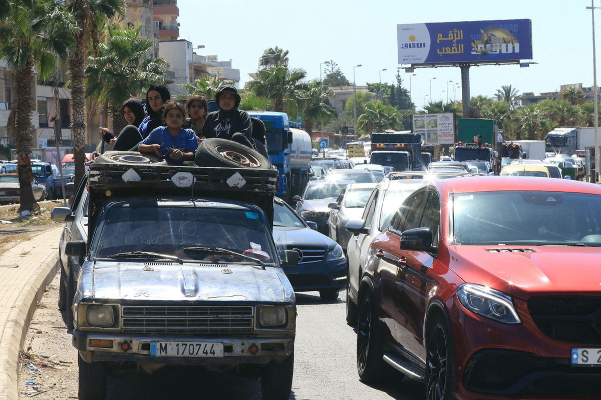 <i>Mahmoud Zayyat/AFP/Getty Images via CNN Newsource</i><br/>A Syrian family sit with their belongings in the back of a truck as they wait in a traffic jam in the southern Lebanese city of Sidon on September 23.