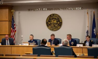 Members of the Coast Guard's Titan Submersible Marine Board of Investigation listen during the hearing inside the Charleston County Council Chambers on September 23