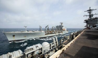 This handout photo from the U.S. Navy shows the Henry J. Kaiser-class fleet replenishment oiler USNS Big Horn sailing alongside the aircraft carrier USS Abraham Lincoln on Sept. 11