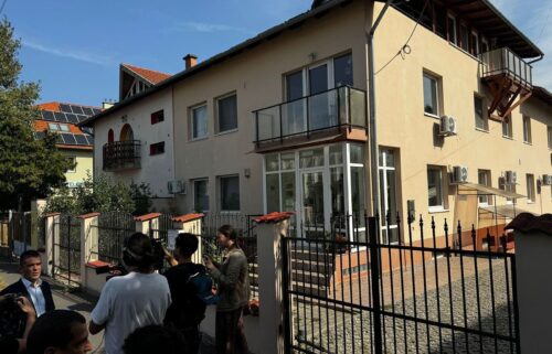 Reporters gathered outside the registered address for BAC Consulting in Budapest