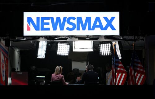 News anchors work at Newsmax's booth during the second day of the 2024 Republican National Convention at the Fiserv Forum in Milwaukee