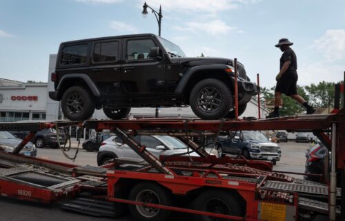 Jeep vehicles are delivered to a dealership on June 20 in Chicago.