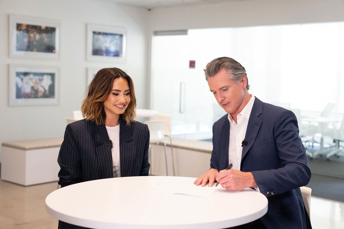 <i>Office of Governor Gavin Newsom via CNN Newsource</i><br/>Demi Lovato joins California Gov. Gavin Newsom to sign legislation to protect the financial security of child influencers.