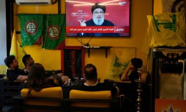 People sit in a cafe in Beirut to watch a speech by Nasrallah on September 19. It came after Israel detonated explosions across Lebanon targeting Hezbollah fighters. Many of those killed were civilians.