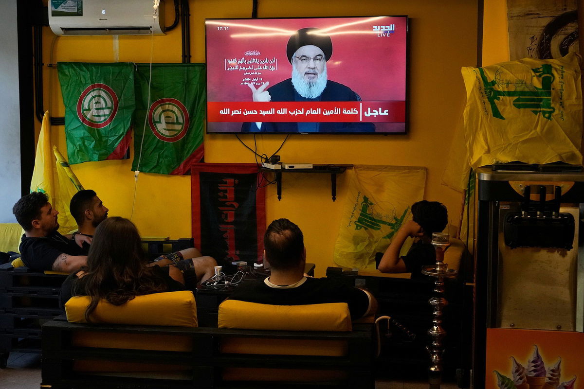 <i>Hassan Ammar/AP via CNN Newsource</i><br/>People sit in a cafe in Beirut to watch a speech by Nasrallah on September 19. It came after Israel detonated explosions across Lebanon targeting Hezbollah fighters. Many of those killed were civilians.