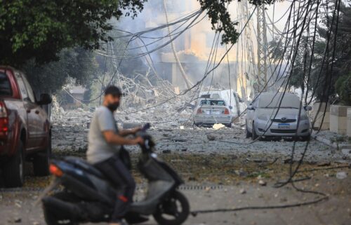 A man rides his motorbike through a neighborhood leveled by Israeli strikes in the Hadath district of Beirut's southern suburbs on September 28.