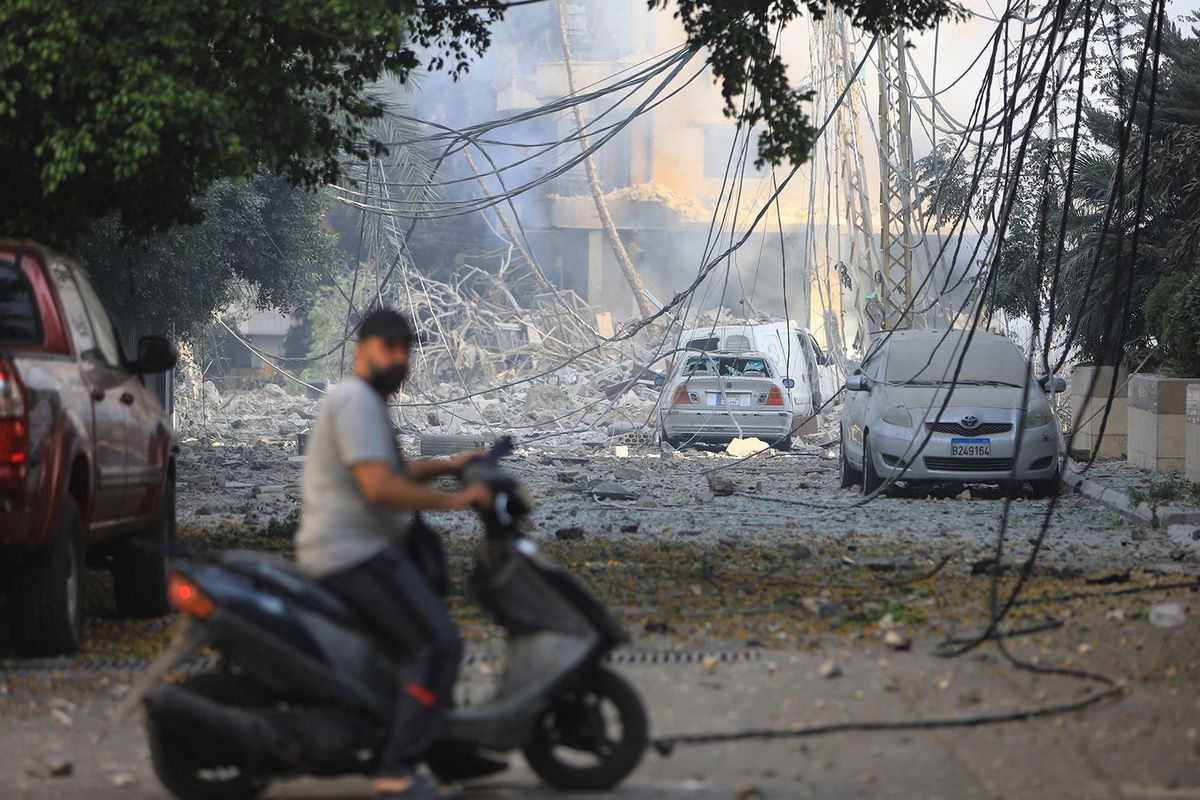 <i>AFP/Getty Images via CNN Newsource</i><br/>A man rides his motorbike through a neighborhood leveled by Israeli strikes in the Hadath district of Beirut's southern suburbs on September 28.