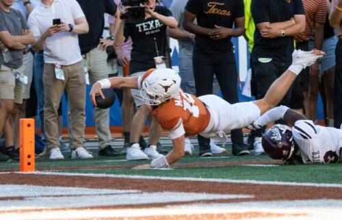 Texas quarterback Arch Manning dives toward the goalline during the second half.