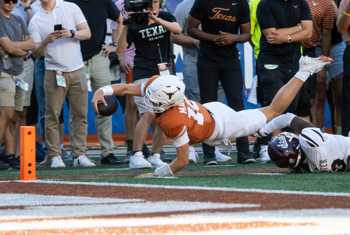 <i>Michael Thomas/AP via CNN Newsource</i><br/>Texas quarterback Arch Manning dives toward the goalline during the second half.