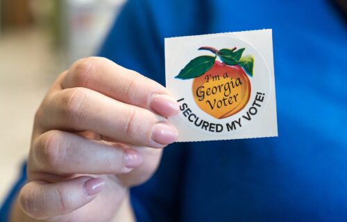 A voter holds up her sticker after casting her ballot for the Primary election on March 12 in Atlanta