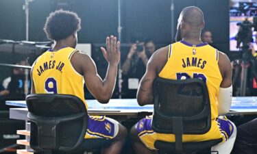 New Los Angeles Lakers guard Bronny James (No. 9) sits next to his dad LeBron James at the Lakers media day at UCLA Health Training Center in El Segundo