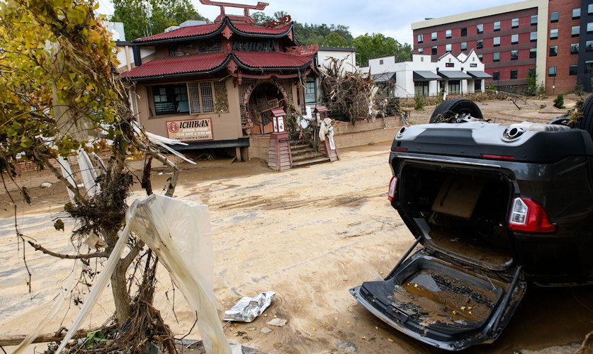 A flood-damaged car lays upside down outside of the Ichiban restaurant in the Biltmore Village in the aftermath of Helene on October 1 in Asheville.