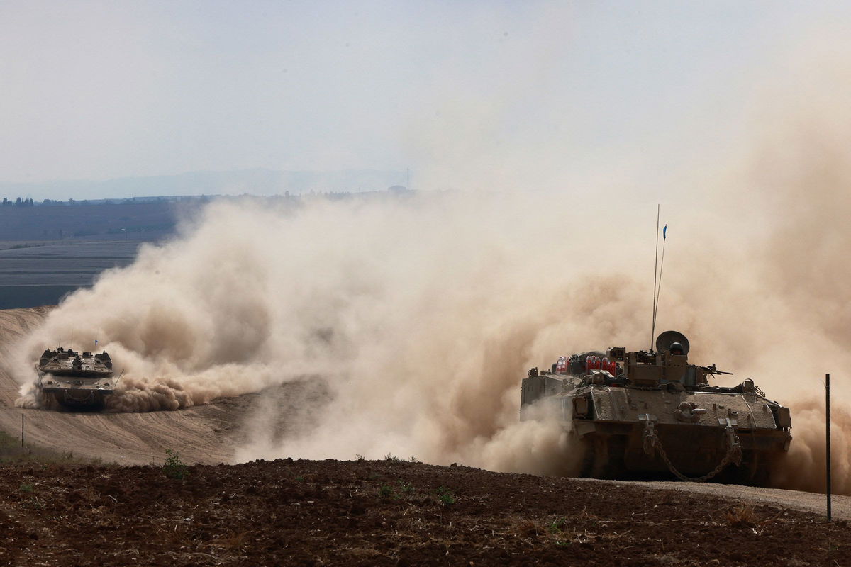 Israeli army tanks drive in an area near Israel's southern border with the Gaza Strip on October 6.