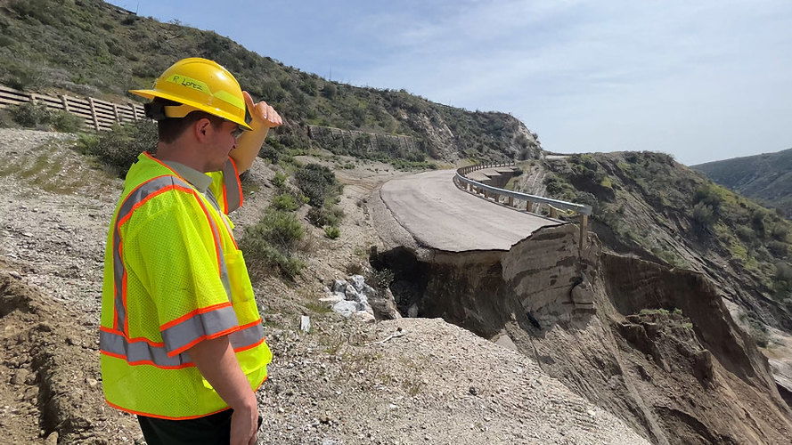 Inspection of a storm-damaged roadway in California in 2023.