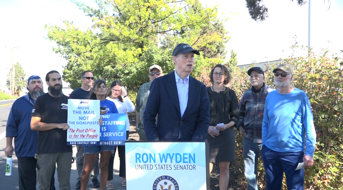 Senator Ron Wyden, joined by Bend Mayor Melanie Kebler and American Postal Workers Union members, voiced criticism of US Postal Service consolidation moves in Oregon to reporters at a news conference Wednesday outside Bend's main post office.