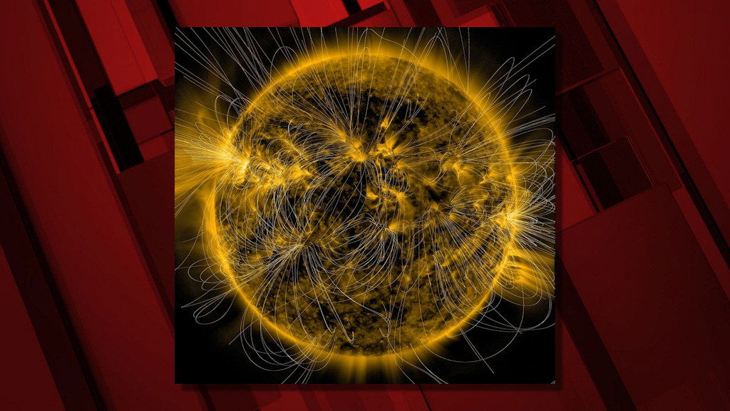 A depiction of the Sun’s magnetic fields is overlaid on an image of the Sun captured in extreme ultraviolet light by NASA’s Solar Dynamics Observatory on March 12, 2016.