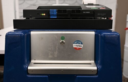 An "I Voted" sticker is displayed on a demonstration ballot lock box beneath a Dominion Voting Machines tabulator at the Maricopa County Tabulation and Election Center on June 3.