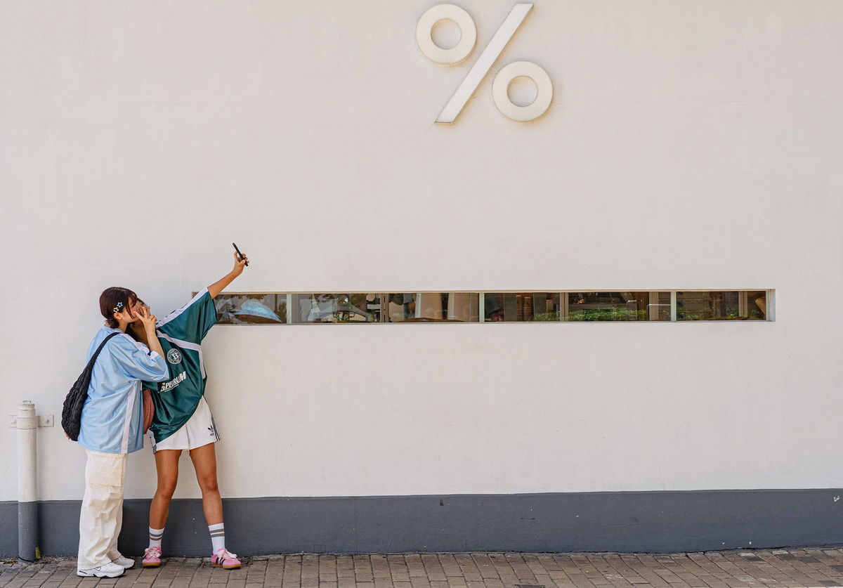 <i>Noemi Cassanelli/CNN via CNN Newsource</i><br/>Girls take pictures in front of a Kennedy Town district cafe in Hong Kong.