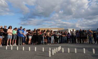 Candles are set out in the shape of a cross where almost 200 people gathered for a candlelight vigil on Thursday for the Erwin