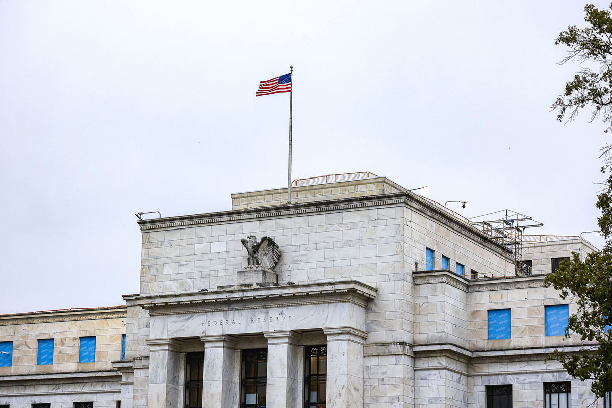 <i>Valerie Plesch/picture-alliance/dpa/AP via CNN Newsource</i><br/>The US flag flies over the Federal Reserve on October 3 in Washington