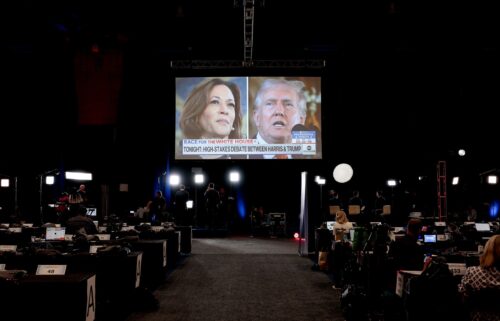 Vice President Kamala Harris and former President Donald Trump are seen on a TV screen at the Pennsylvania Convention Center in Philadelphia on September 10