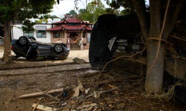 Flood-damaged cars are strewn about Biltmore Village across from the Biltmore Estate in Asheville in the aftermath of Hurricane Helene on October 1.