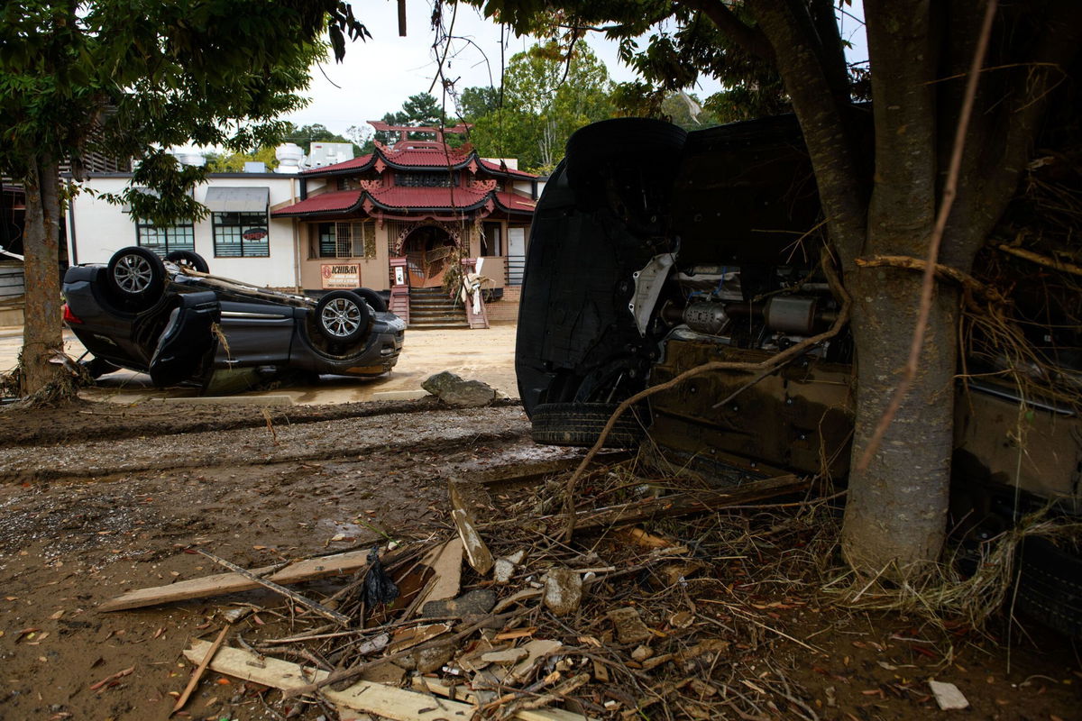 <i>Melissa Sue Gerrits/Getty Images via CNN Newsource</i><br/>Flood-damaged cars are strewn about Biltmore Village across from the Biltmore Estate in Asheville in the aftermath of Hurricane Helene on October 1.