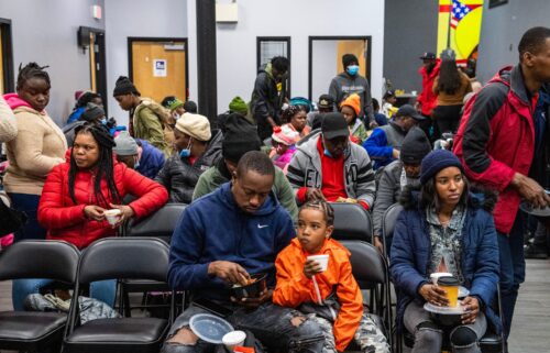 Migrants eat a meal at the La Colaborativa day shelter in Chelsea