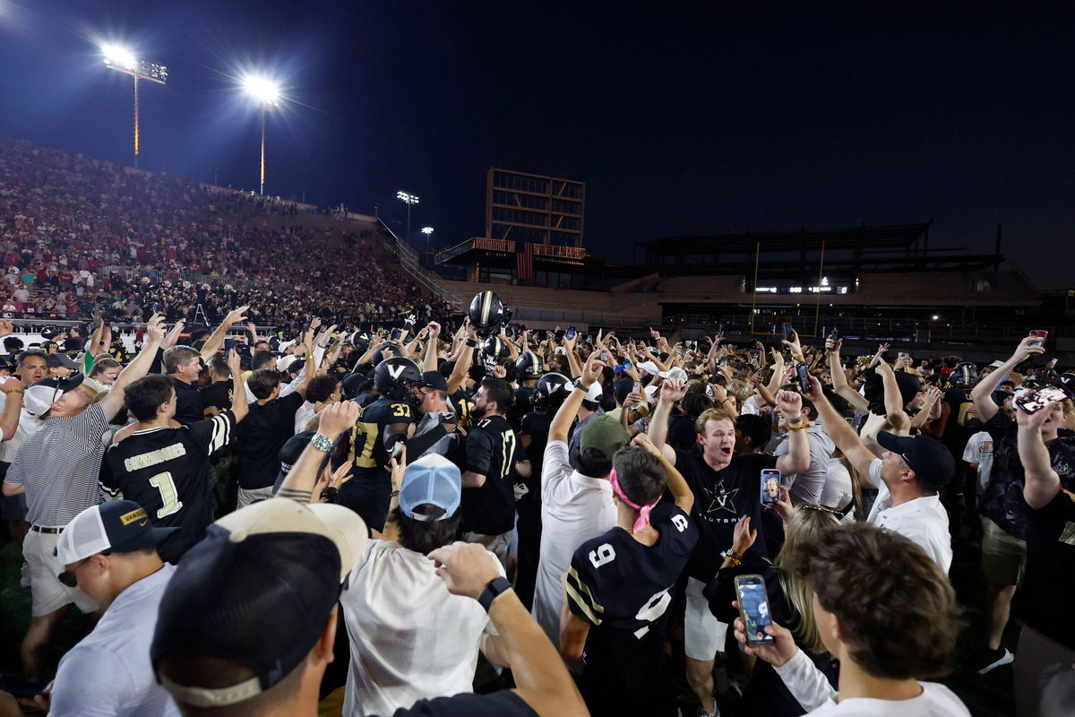 <i>Matthew Maxey/Icon Sportswire/Getty Images via CNN Newsource</i><br/>Vanderbilt Commodores players and fans celebrate following their win.