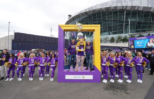 Vikings fans pose with the team's mascot VIktor and cheerleaders before the game against the Jets.