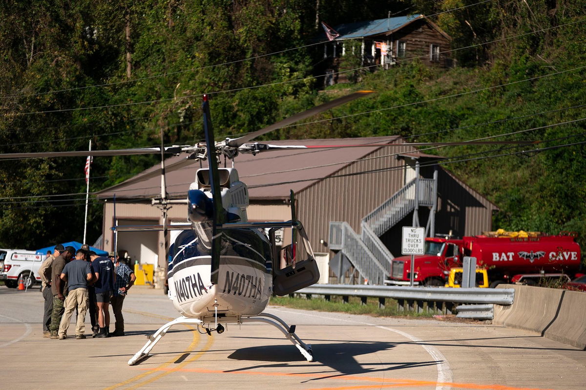 <i>Sean Rayford/Getty Images via CNN Newsource</i><br/>A helicopter pilot meets with people on the ground in the aftermath of Hurricane Helene on October 3