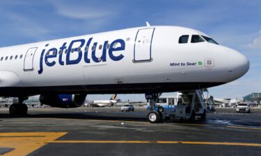 A JetBlue airplane sits on the tarmac at John F. Kennedy International Airport in New York in 2017. JetBlue’s economy class passengers will no longer find hot meals on the menu aboard transatlantic flights.