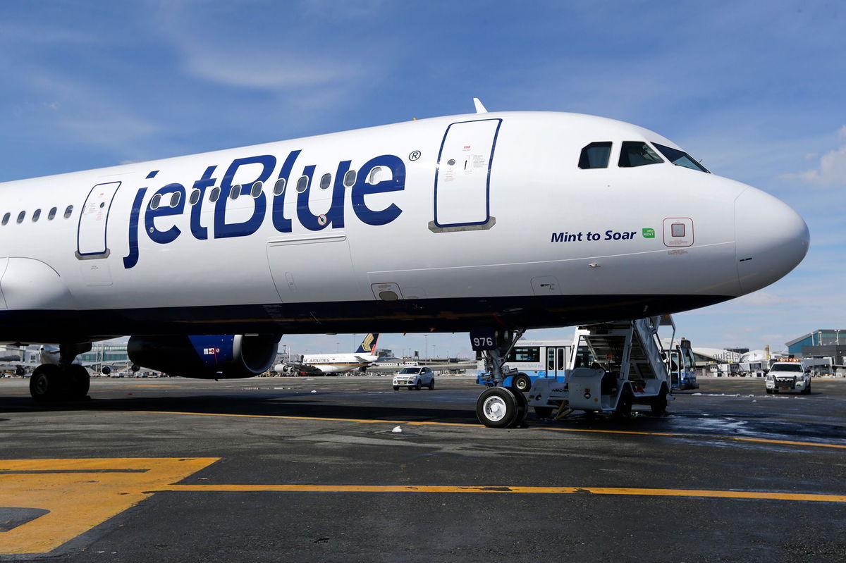 <i>Seth Wenig/AP via CNN Newsource</i><br/>A JetBlue airplane sits on the tarmac at John F. Kennedy International Airport in New York in 2017. JetBlue’s economy class passengers will no longer find hot meals on the menu aboard transatlantic flights.