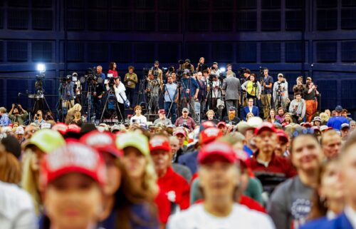 Members of the press stand at the back of a rally for former President Donald Trump in Bozeman