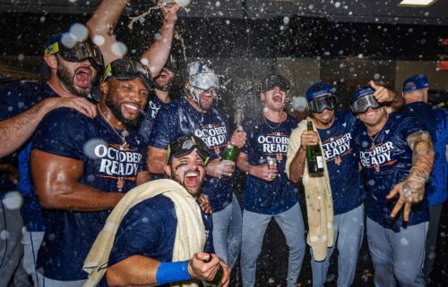 The New York Mets celebrate in the locker room after clinching a playoff berth with their come-from-behind victory against the Atlanta Braves.