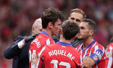 Atlético Madrid defender Robin Le Normand (No. 24) stands after inadvertently clashing heads with Aurelien Tchouameni of Real Madrid.