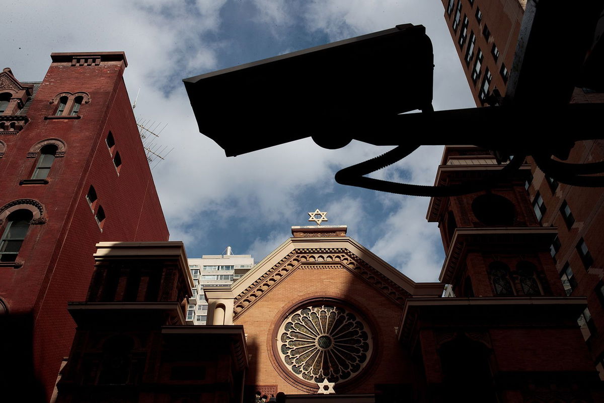 <i>Drew Angerer/Getty Images/File via CNN Newsource</i><br/>A security camera hangs across the street from the Park East Synagogue