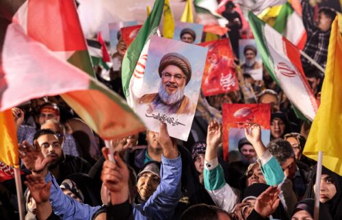 A demonstrator holds a sign showing the face of Hezbollah's slain leader Hassan Nasrallah