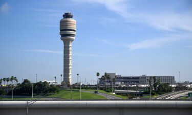 The FAA air traffic control tower is pictured at Orlando International Airport. The Federal Aviation Administration says that graduates of two college air traffic control programs can now bypass the agency’s backlogged training academy.