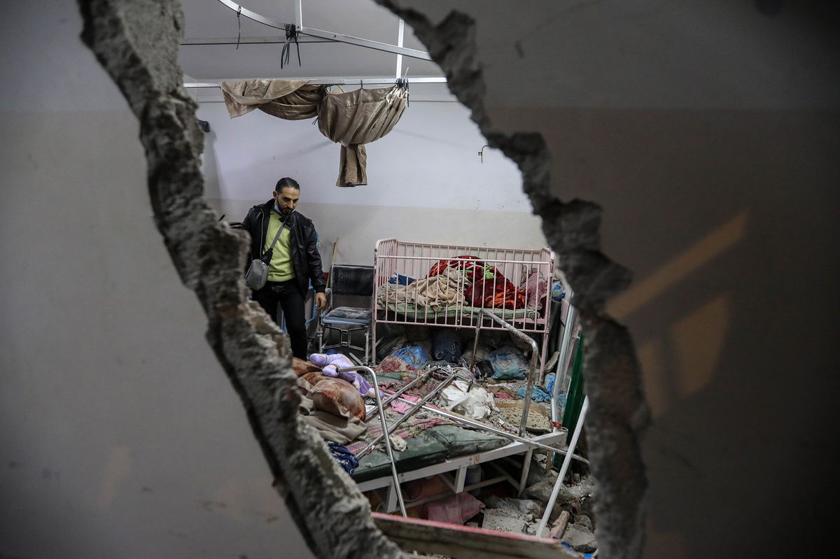 <i>Ahmad Hasaballah/Getty Images via CNN Newsource</i><br/>People inspect the damage caused by an artillery shell that hit the maternity hospital inside the Nasser Medical Complex