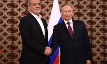 Putin and Pezeshkian shake hands during their first meeting