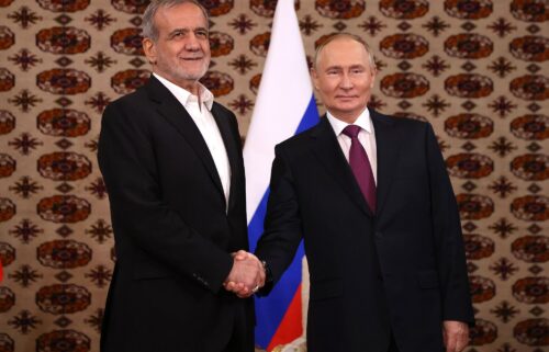 Putin and Pezeshkian shake hands during their first meeting