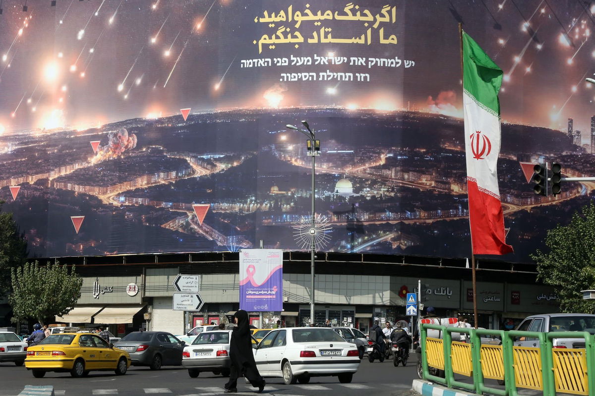 <i>Fatemah Bahrami/Anadolu/Getty Images via CNN Newsource</i><br/>People walk on the streets of Tehran where Iranian flags and Hezbollah banners are seen